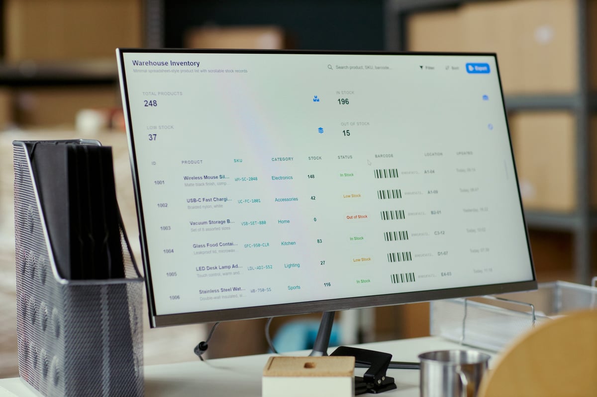 Close up of desktop monitor displaying warehouse inventory dashboard, tracking stock levels, barcodes, product records for logistics management